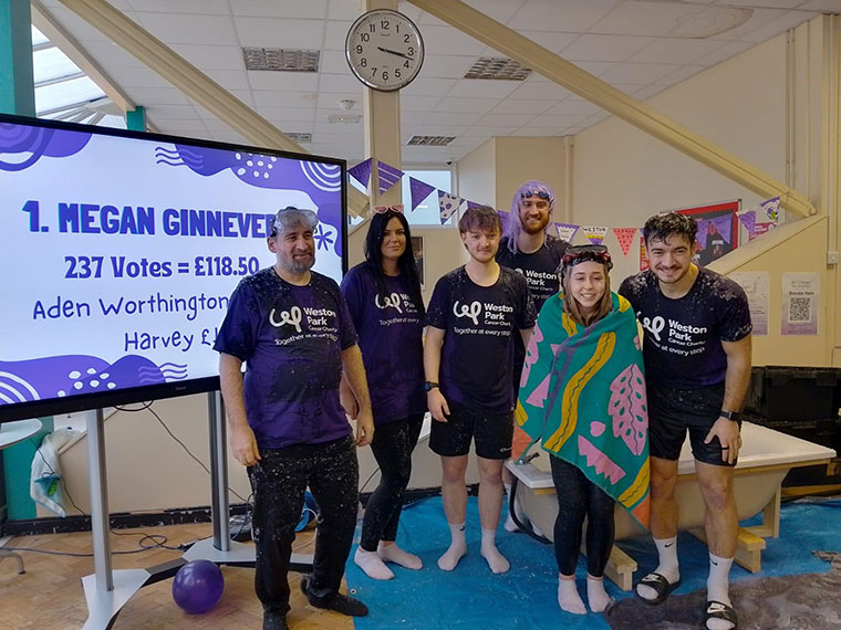 Staff stood around the slime bath after being slimed on Wear it Purple day