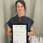 Level 4 Aesthetics student Jodie holding up her certificate