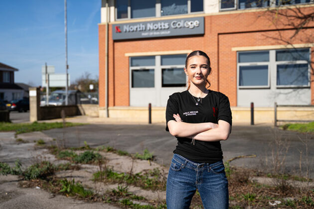 A student stood with their arms folded outside North Notts College