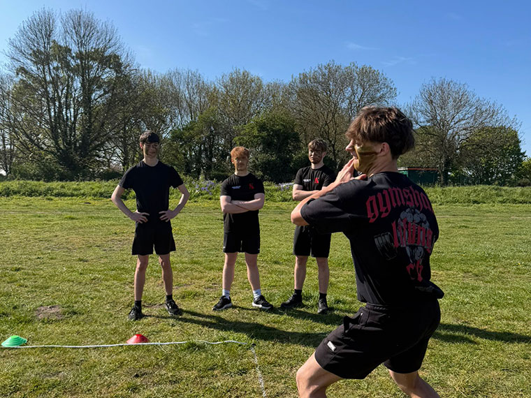 A person preparing to throw something as part of a sports day event