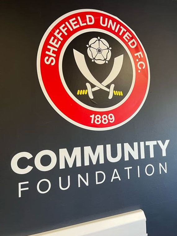Sheffield United Football Club Community Foundation logo up on a wall