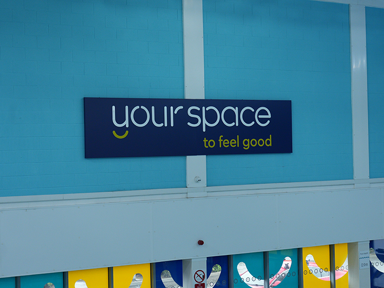 Your Space to feel good sign on a light blue wall