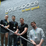 Your Space to feel good written on a wall with four people stood below it on a staircase