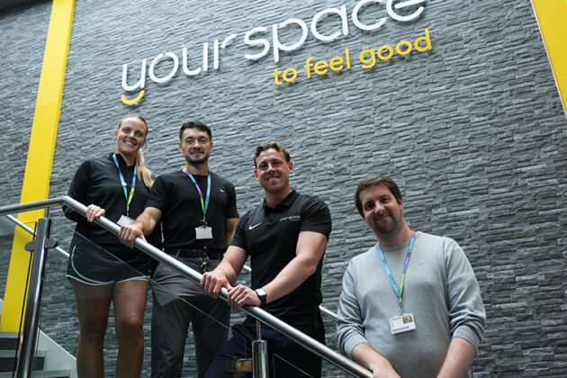 Your Space to feel good written on a wall with four people stood below it on a staircase